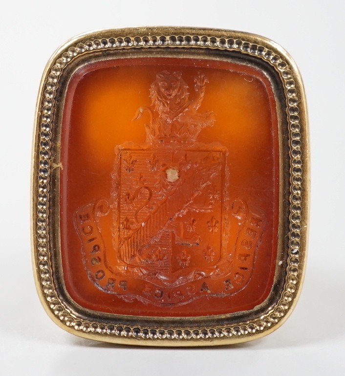 An early 19th century yellow metal overlaid and carnelian set fob seal, the matrix carved with armorial, 29mm.